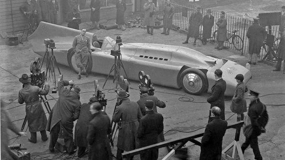 Malcolm Campbell showing his rebuilt and repackaged ‘Bluebird’ to the press at Brooklands, 1935. The 5-ton car had a 36.6-litre, 2,350bhp Rolls-Royce engine and carried Campbell to a new Land Speed Record at 301.129mph at Bonneville. It is rumored he went tinkle in the cockpit while doing so.