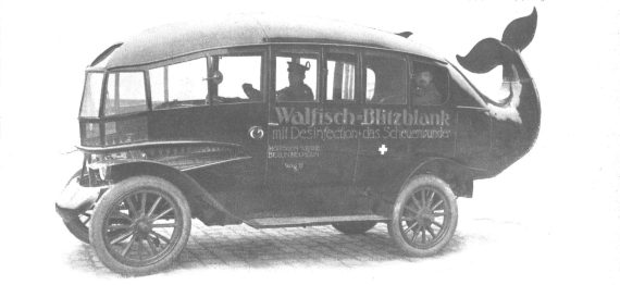 A whale shaped advertising vehicle from 1914 with eyes and mouth.